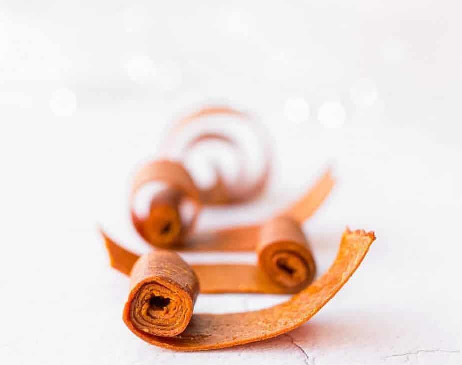 apple sauce fruit roll up rolled into beautiful swirls on a bright white surface sized for cover image