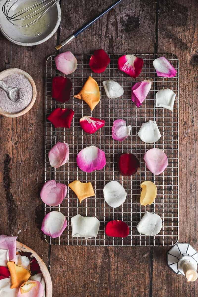 overhead shot of fresh rose petals on a cooling rack