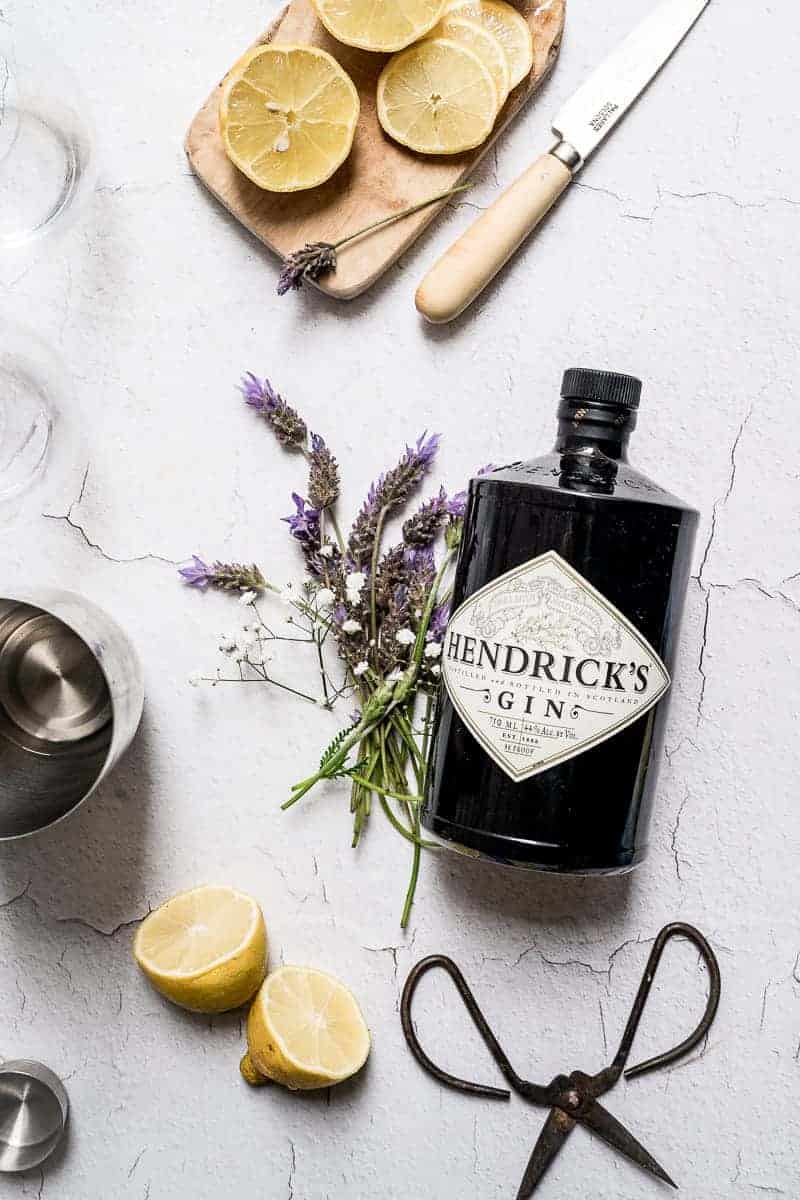 overhead shot of bottle of Hendrix gin flat with fresh lavender flowers styled next to it