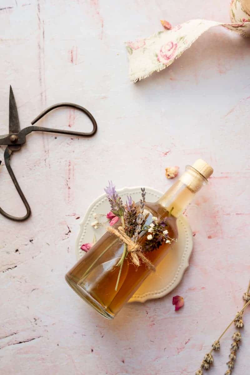 overhead shot with lavender honey simple syrup with dried lavender flowers tied on the bottle with twine