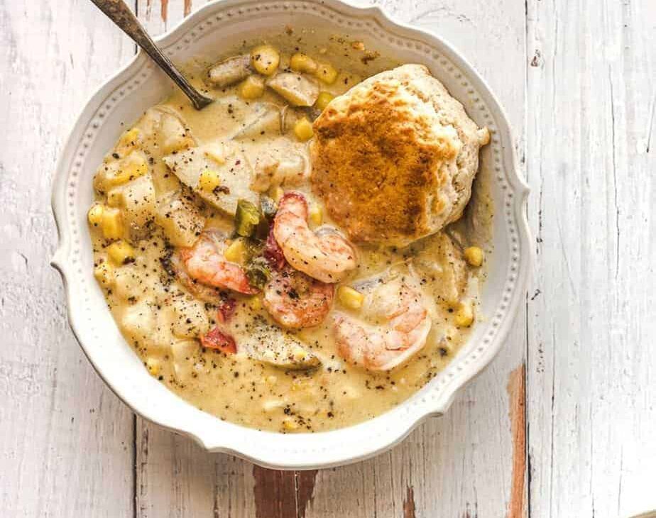 vintage bowl of creamy corn and shrimp chowder with a fresh biscuit