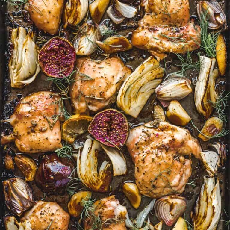 overhead shot of oven roasted chicken with fennel and figs on baking sheet