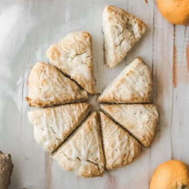 over head image of orange ginger scones with one scone pulled from the center