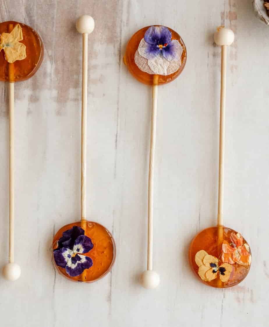 honey spoons filled with edible flowers pansies