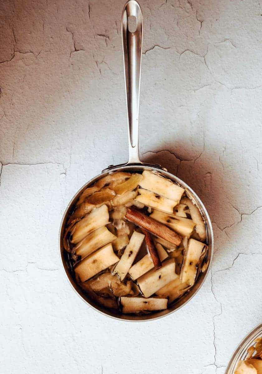 apple cores and cinnamon sticks in a medium sauce pan for ingredients for apple peel pancake syrup