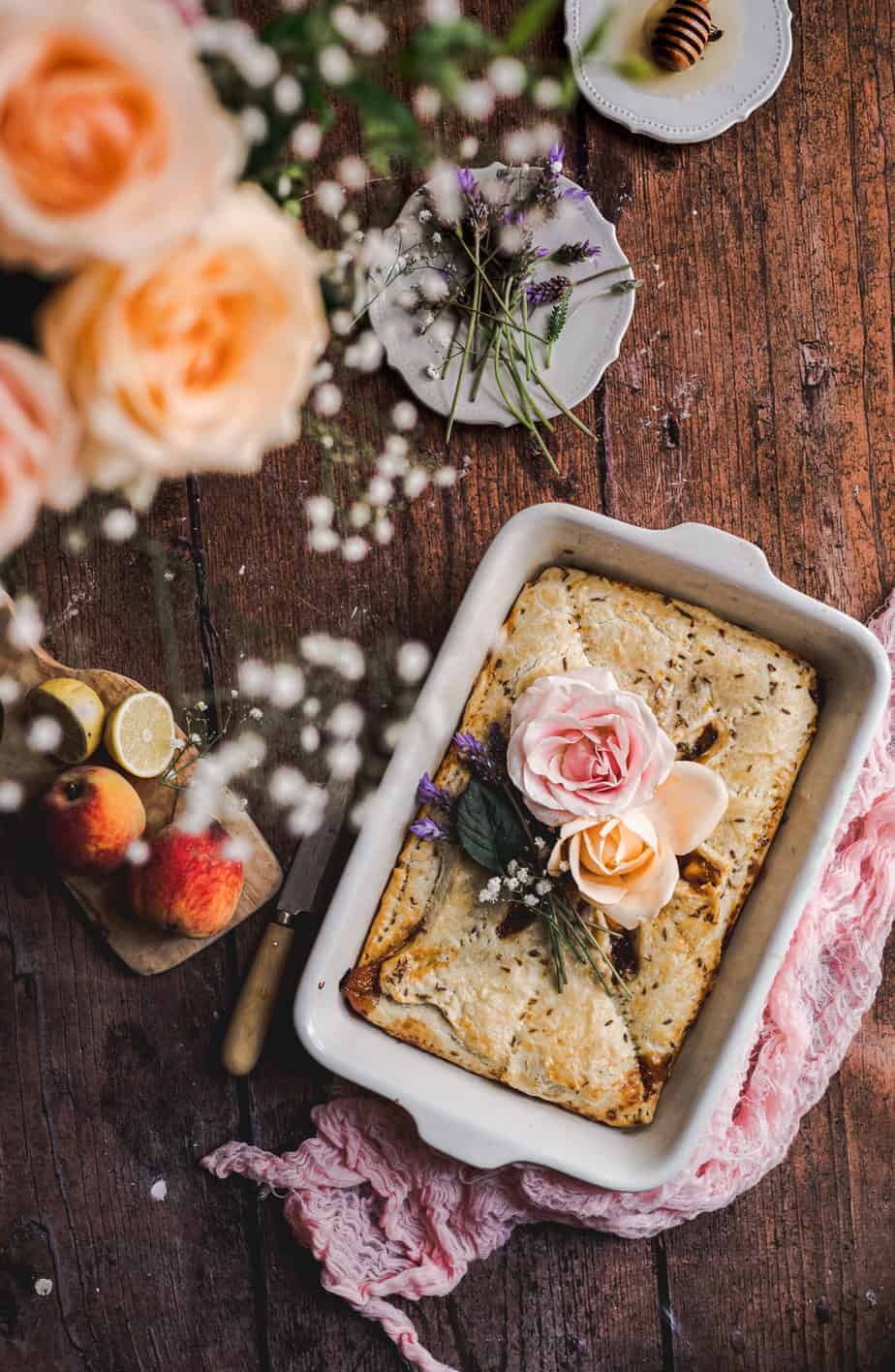 overhead rustic shot with lavender peach pie slab, styled with roses