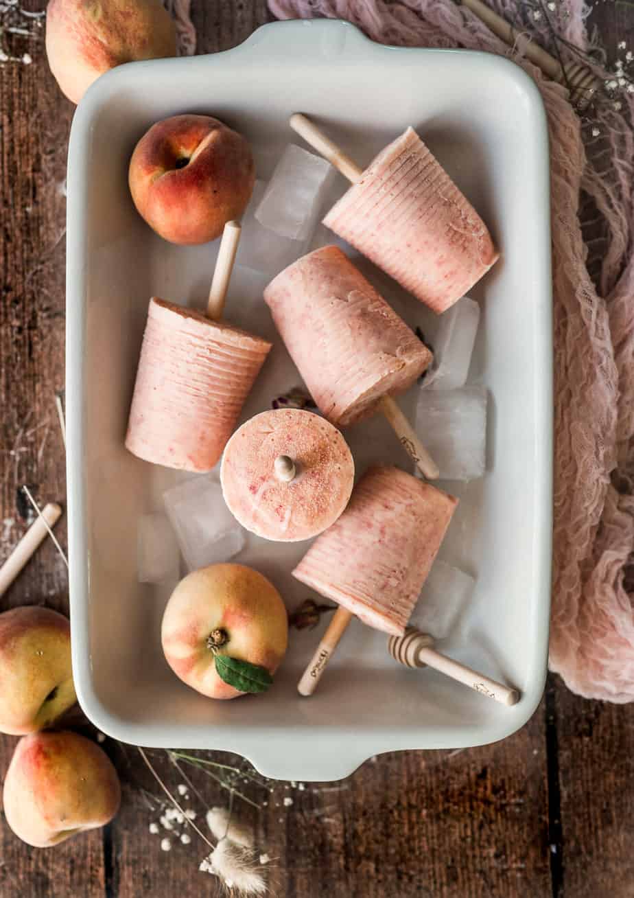 baking dish with ice and 4 popsicles styled in different directions