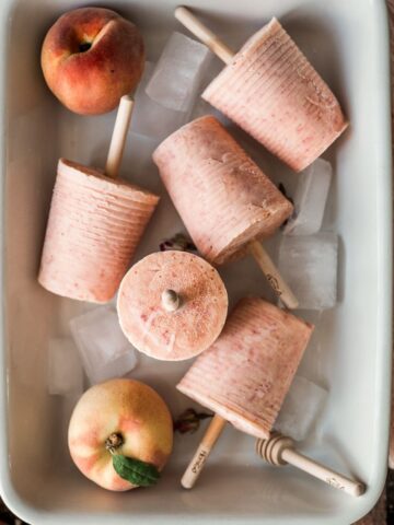 peaches and cream peach colored popsicles in a baking dish, styled in different directions cover