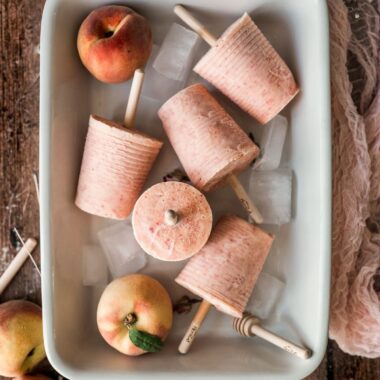 peaches and cream peach colored popsicles in a baking dish, styled in different directions cover