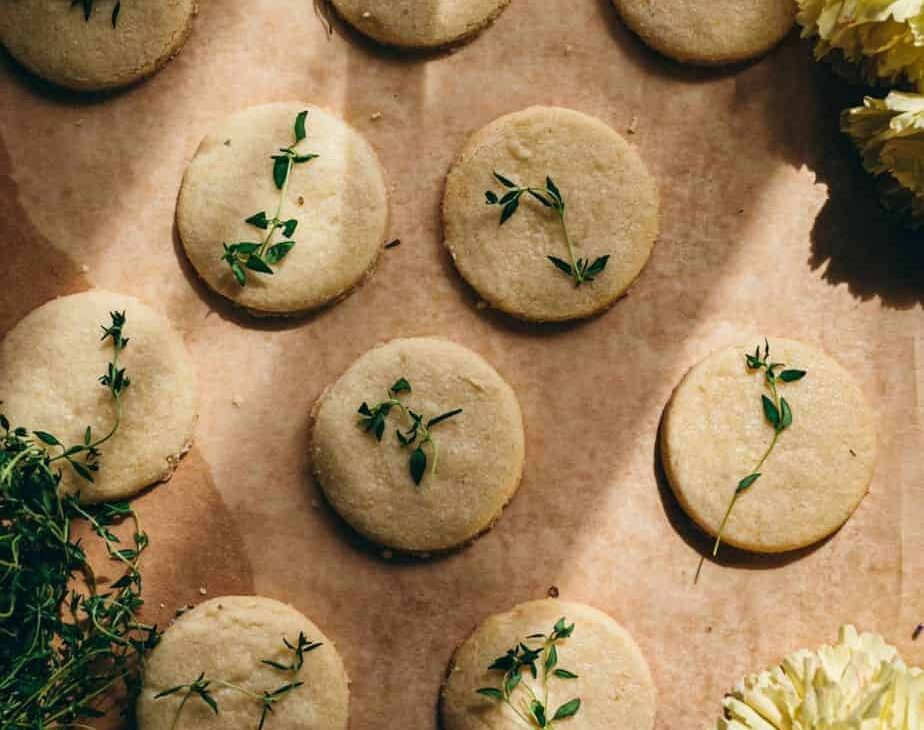 overhead shot of harsh light on lemon thyme shortbread lined up symmetrically