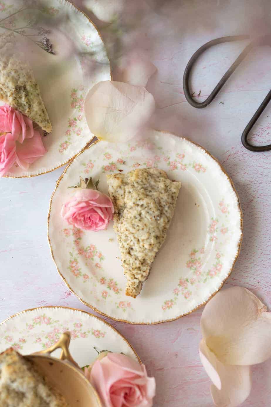 overhead image of single scone on vintage pink and white dessert plate with a pink rose