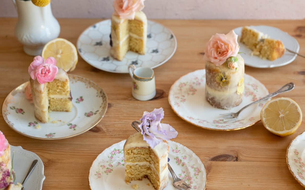 plates of mini cakes topped with flowers