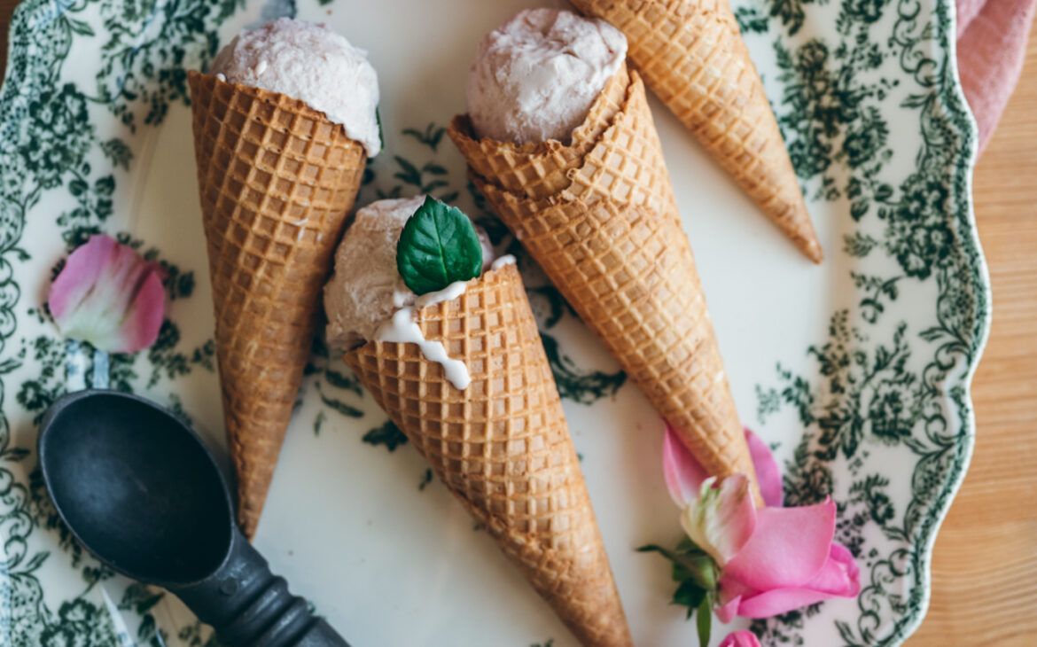 vintage victorian green tray with tan waffle cones filled with pink rose ice cream, next to a vintage ice cream scoop and some pink roses