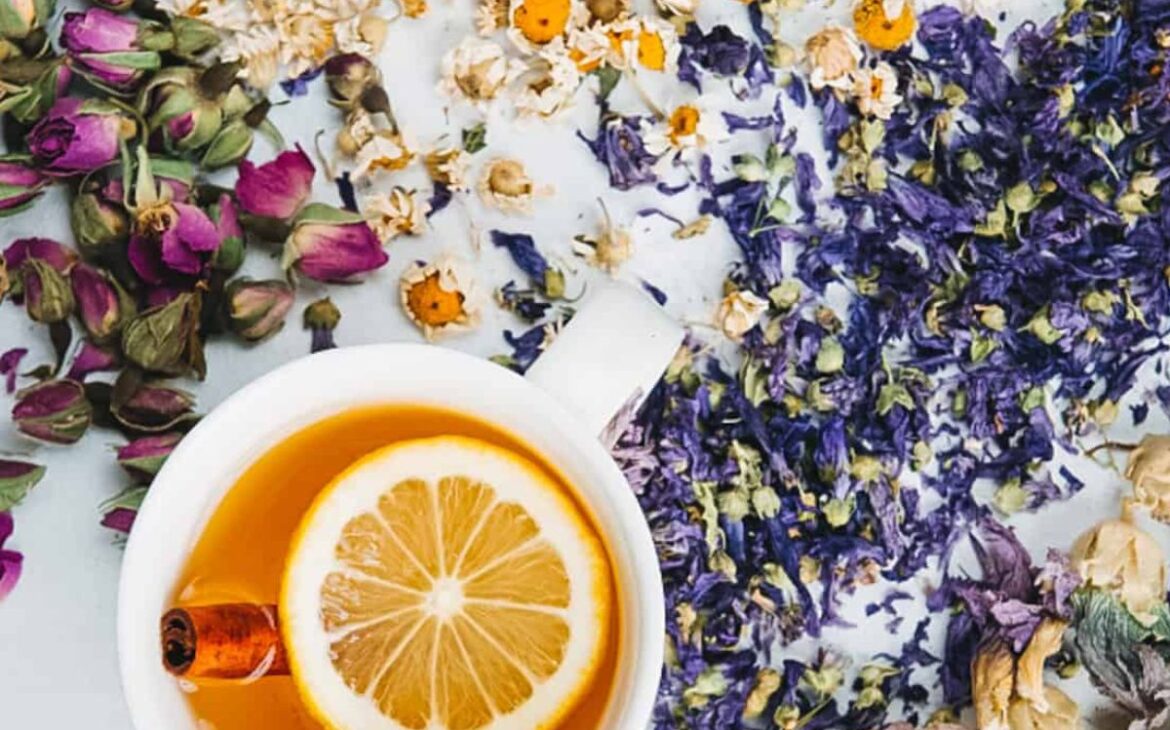 overhead image of dried flowers next to a cup of lemon tea