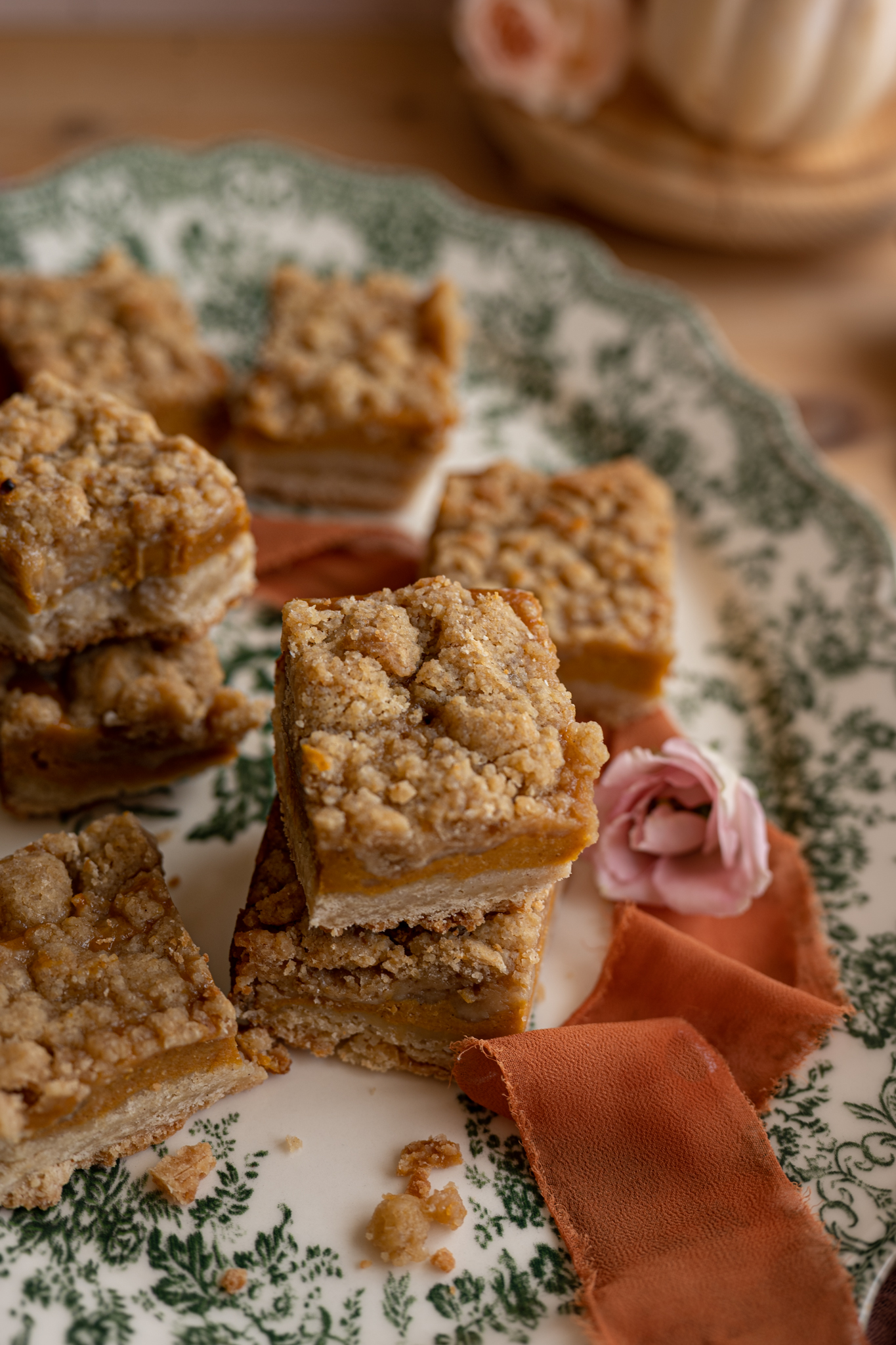 crumble topping on pumpkin shortbread bars stacked on top of each other