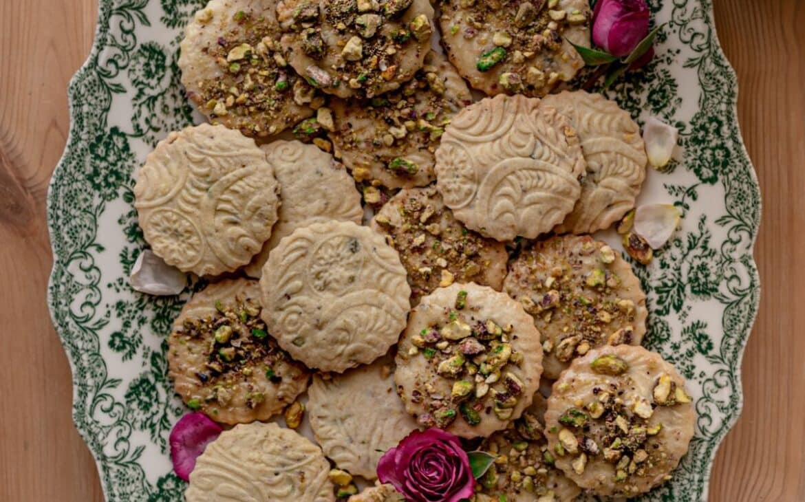 cover image of salted honey pistachio cookies with pistachio cookies and pink roses