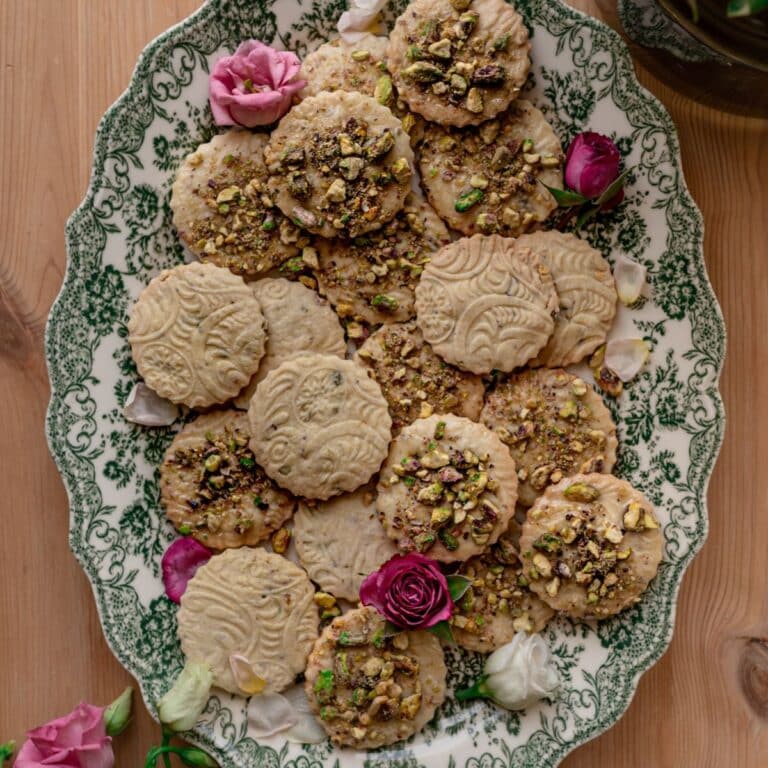 cover image of salted honey pistachio cookies with pistachio cookies and pink roses