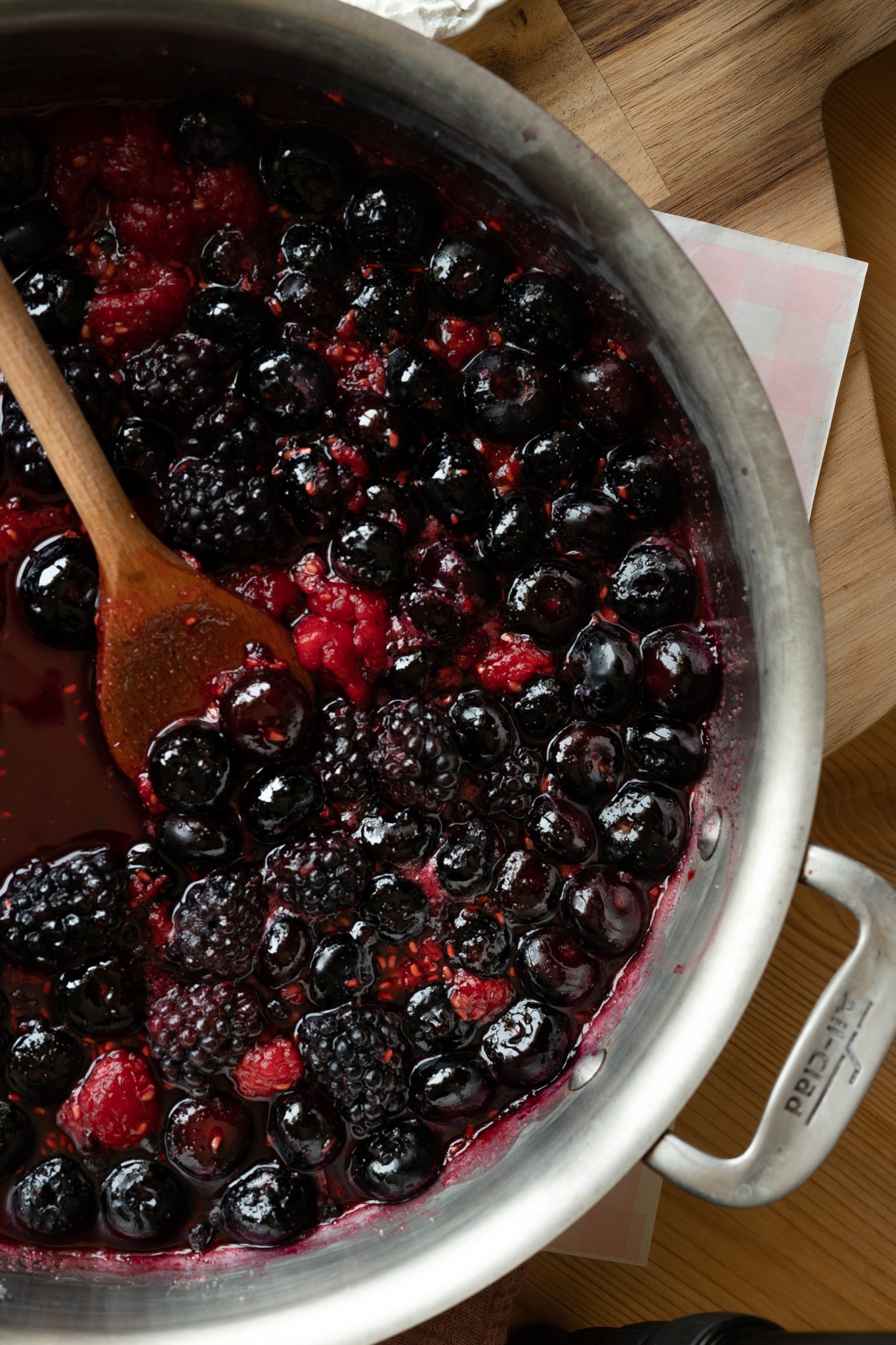 overhead shot of berry filling bubbling in all clad pan