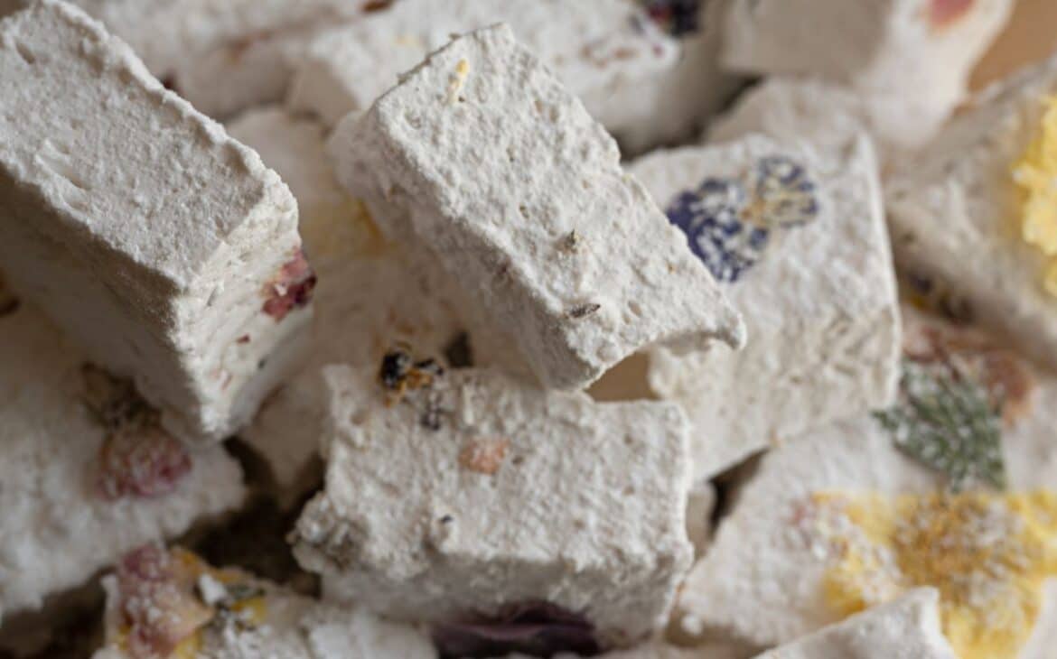 close up image of homemade marshmallow root marshmallows garnished with edible flowers