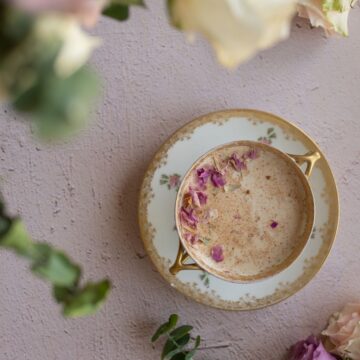 CLOSE UP OVERHEAD IMAGE OF VINTAGE ROSE cup with rose moon milk inside