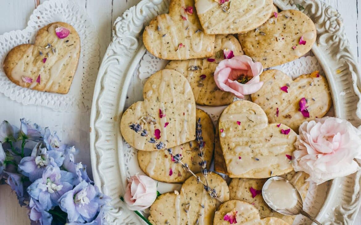lavender earl grey cookies on a vintage platter next to bouquet of pretty blue flowers