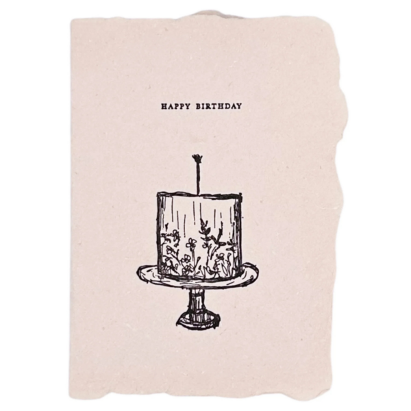 a pink handmade paper birthday card with a drawing of a cake with edible flowers on it