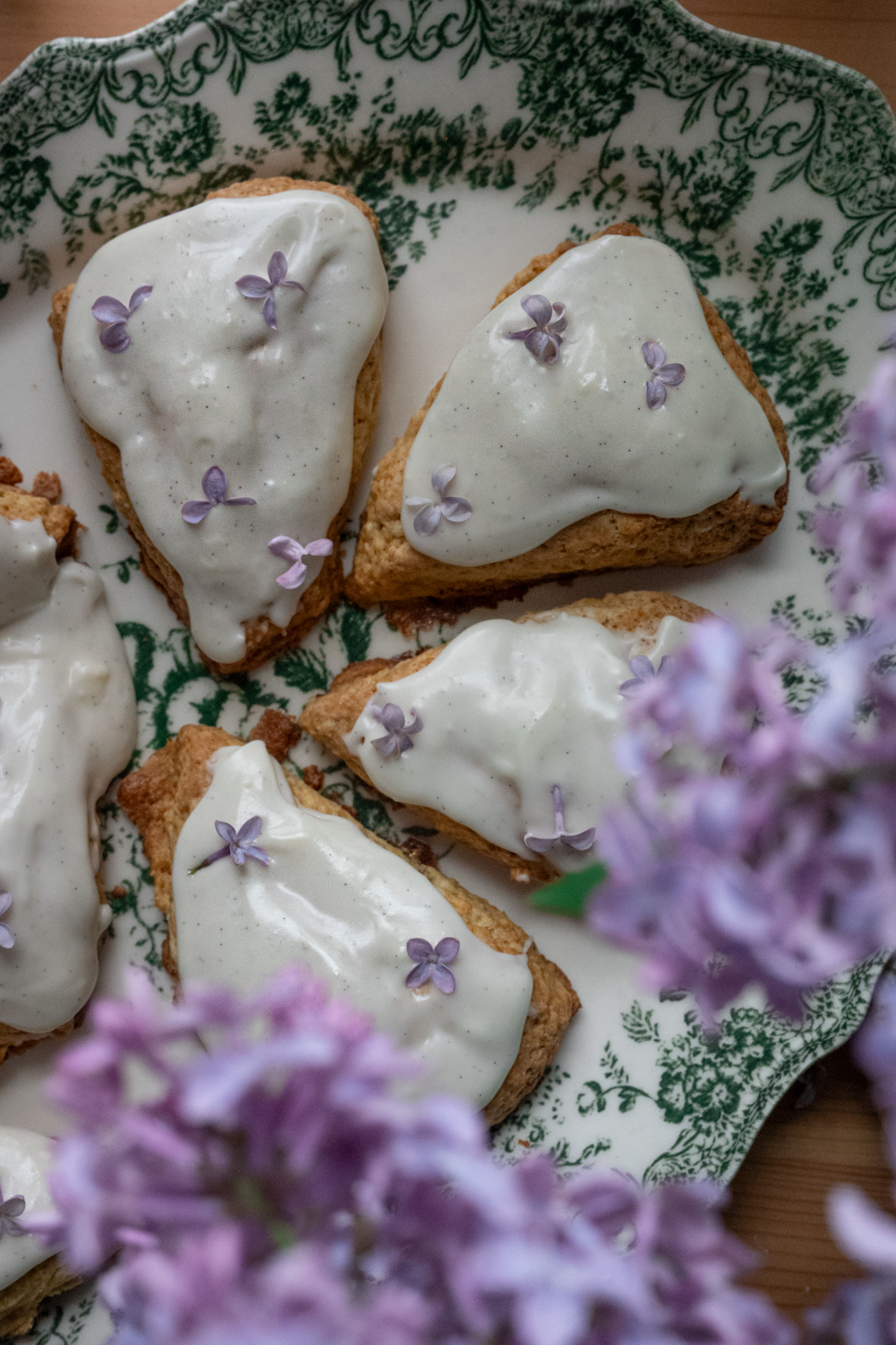 a plate of pastries with purple flowers